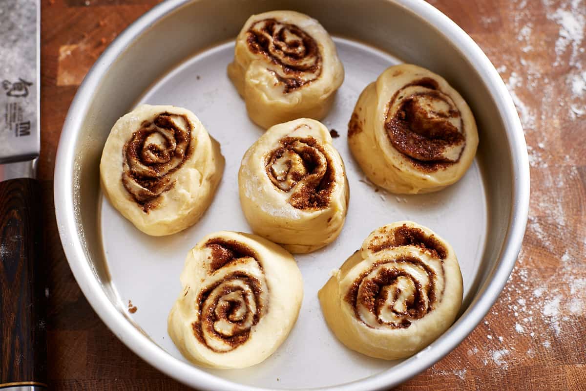 Cut, unbaked rolls in a baking pan