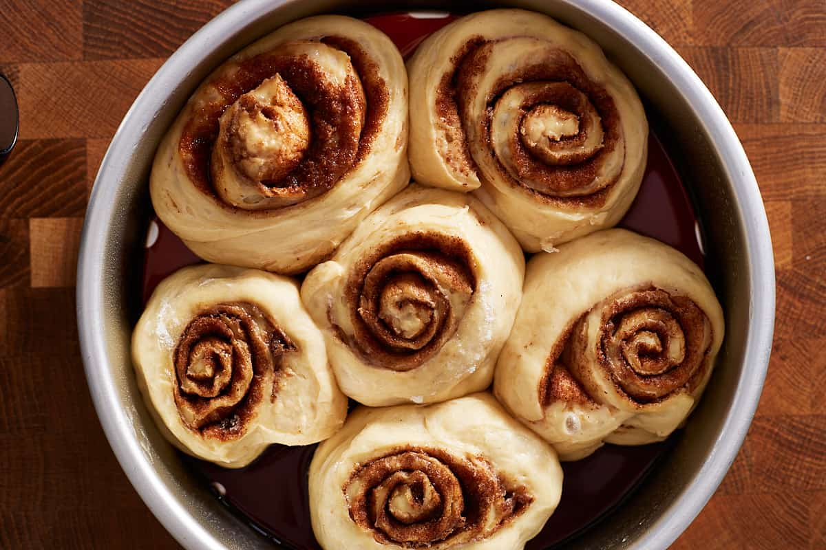 Risen, unbaked rolls in a baking pan