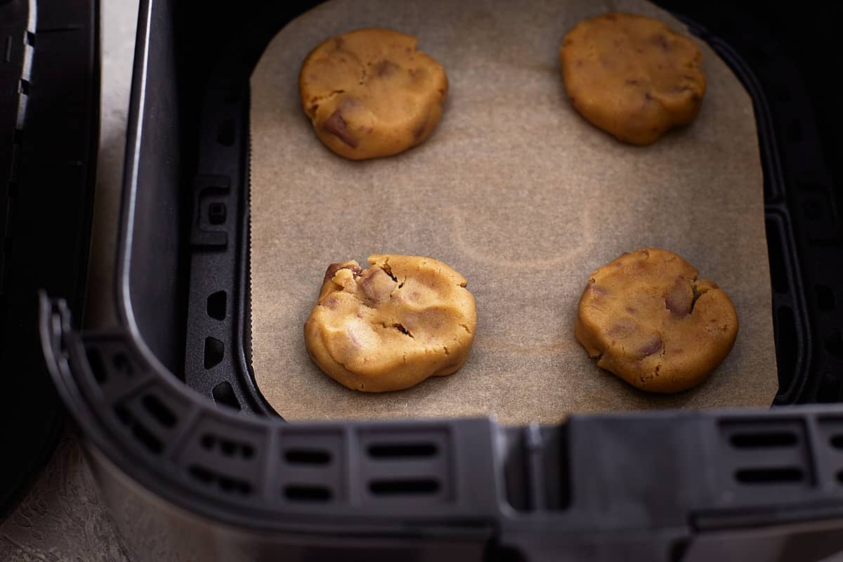 Unbaked cookie dough in air fryer basket