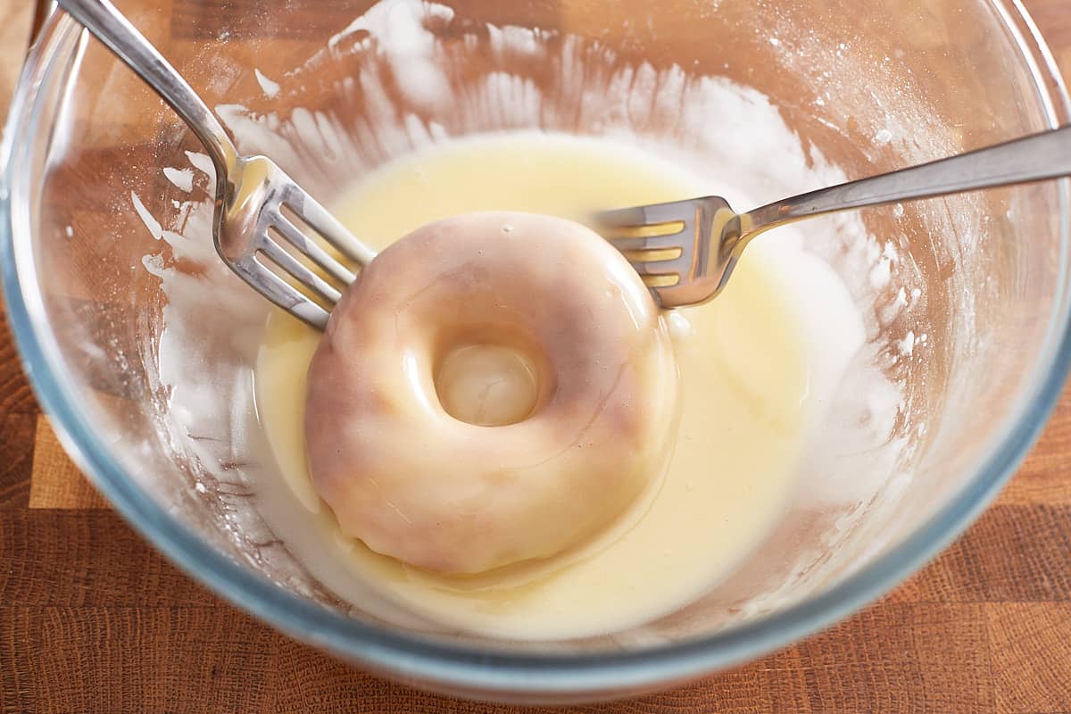 Glazed donut ring in a bowl of glaze