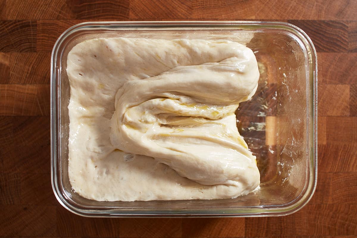 Stretched and folded dough in a glass container