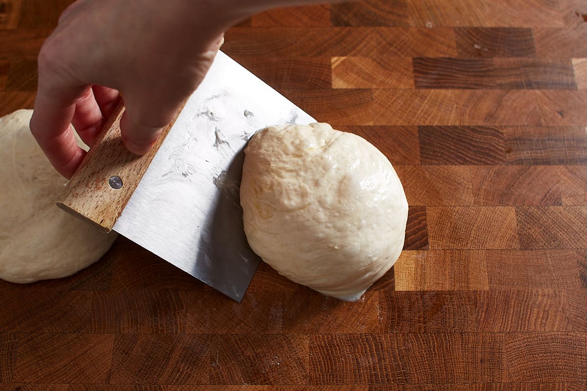 Shaping pizza dough with a bench knife