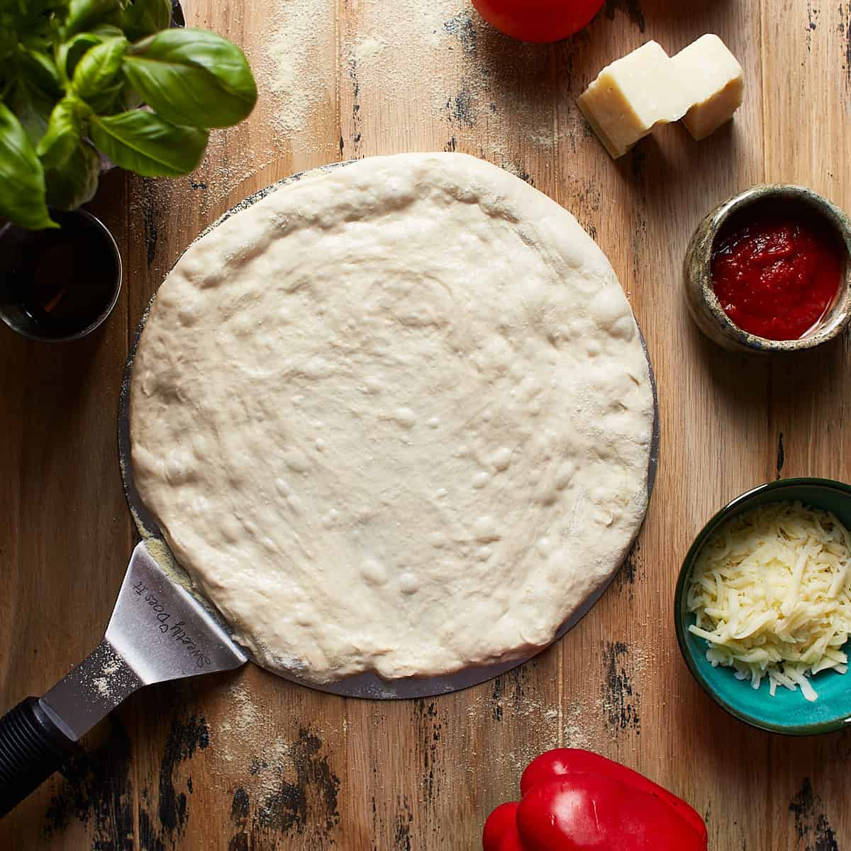 Raw pizza dough on a pizza peel