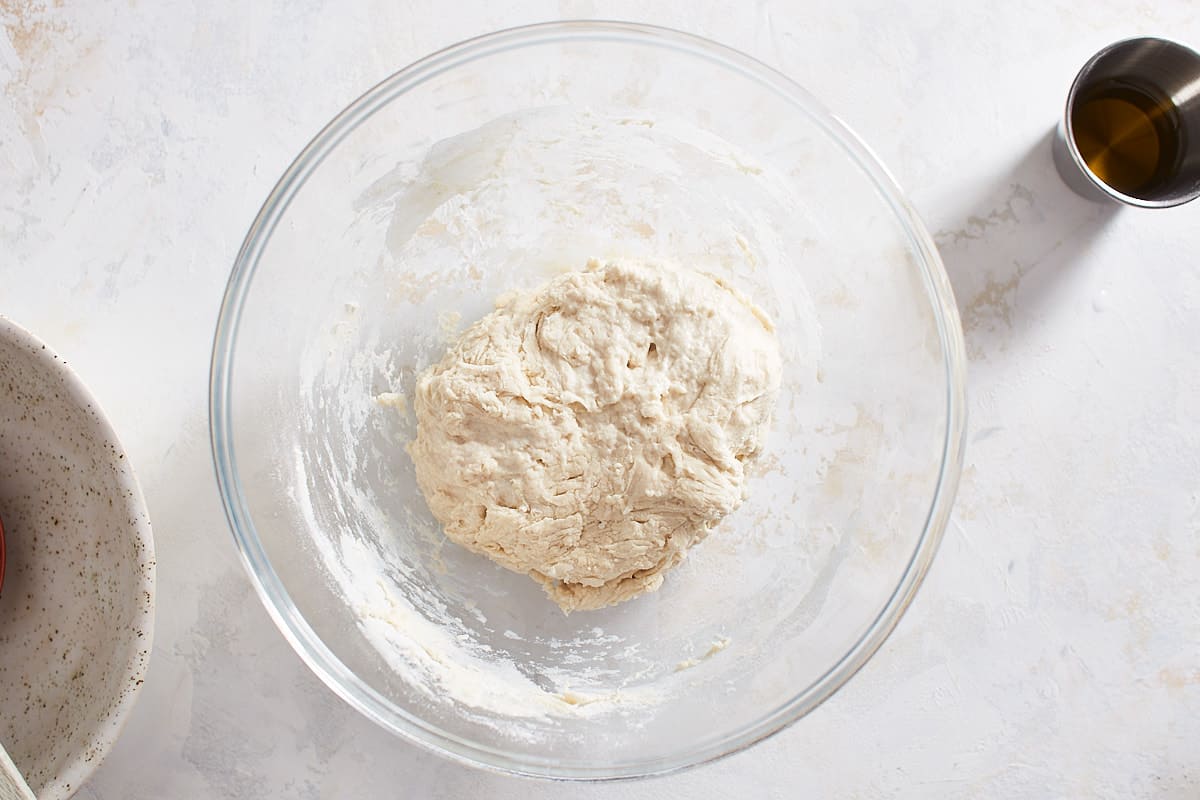Flour, water, salt, and yeast combined in a bowl