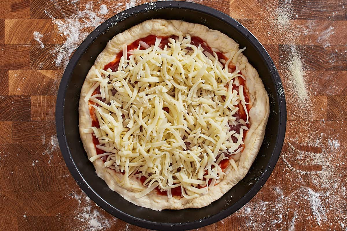Unbaked pizza in a baking pan