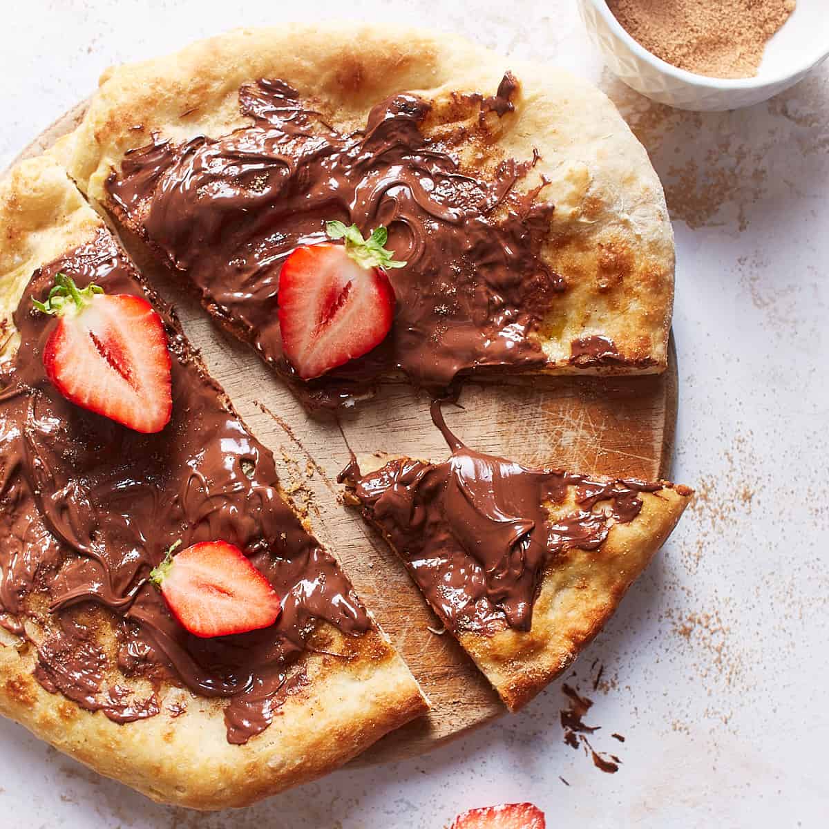 Baked nutella pizza sliced and decorated