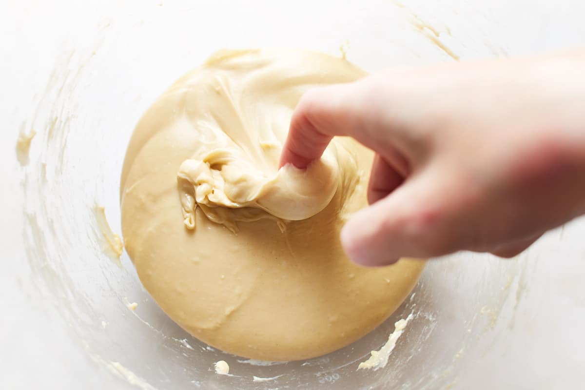 Pulling some dough with a finger