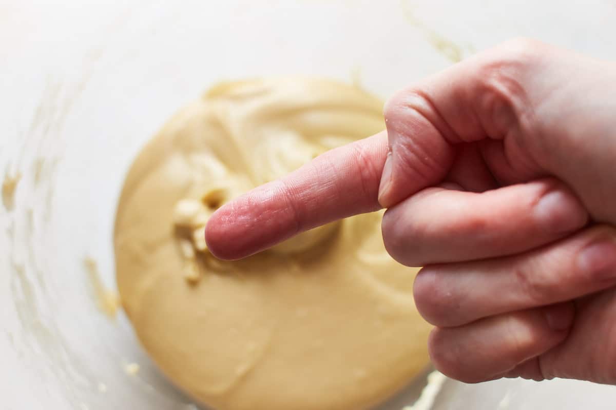 Showing a clean finger after touching the dough