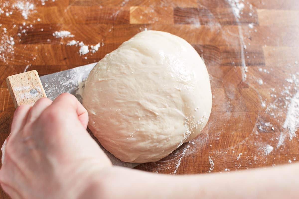 Moving the dough with a bench knife
