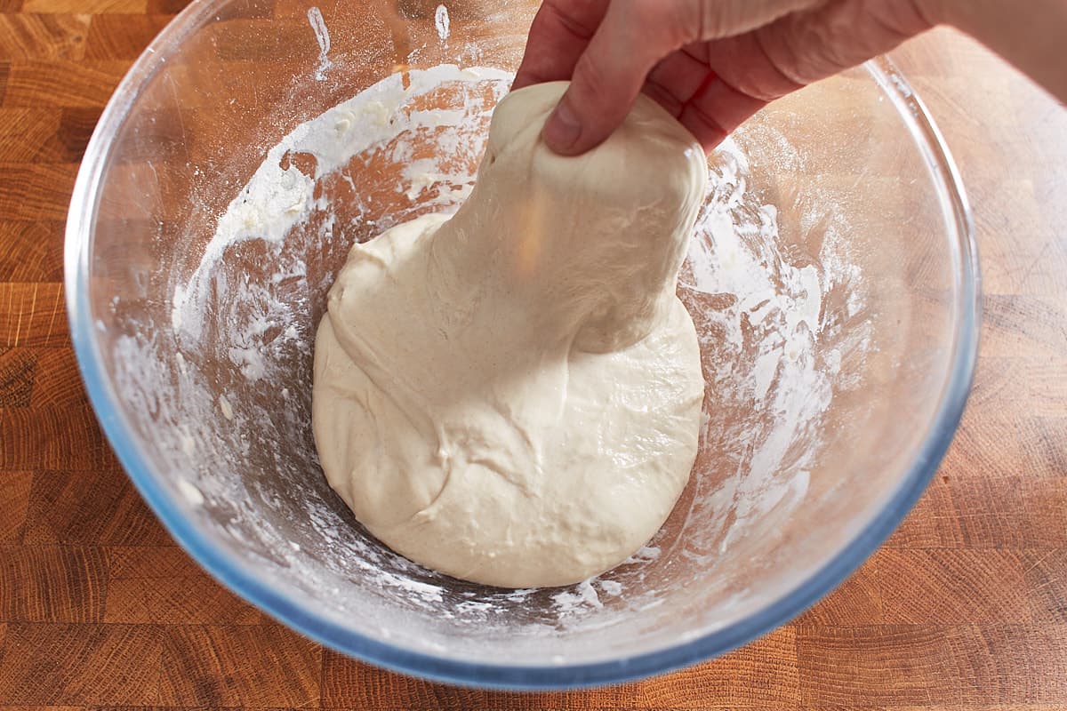 Stretching up one side of the dough