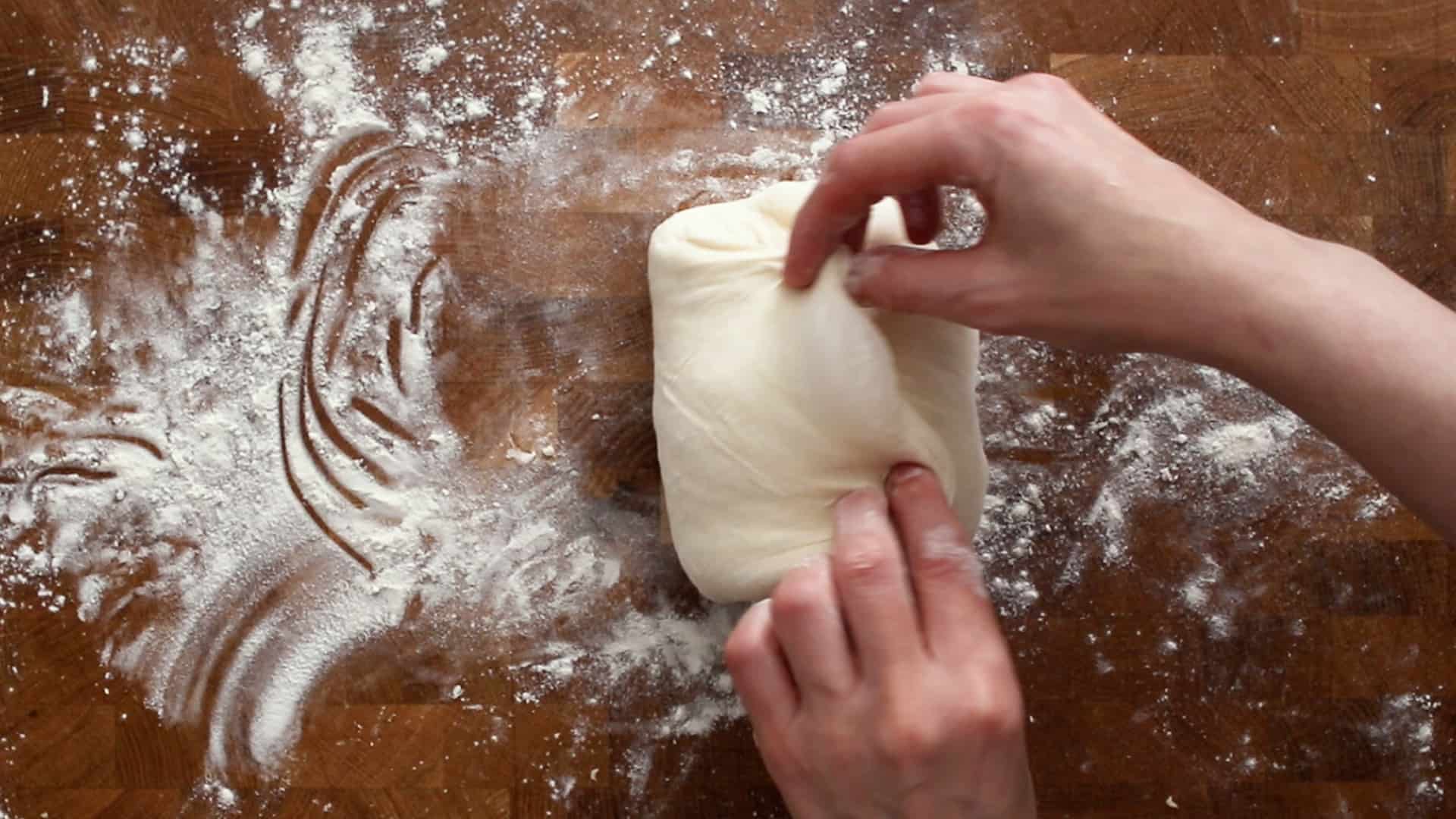 Folding the left dough flap over itself