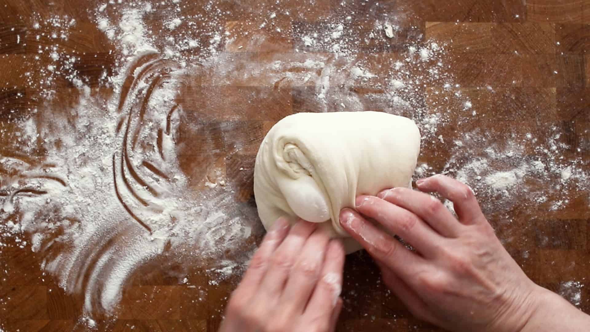 Folding a flap of dough over itself