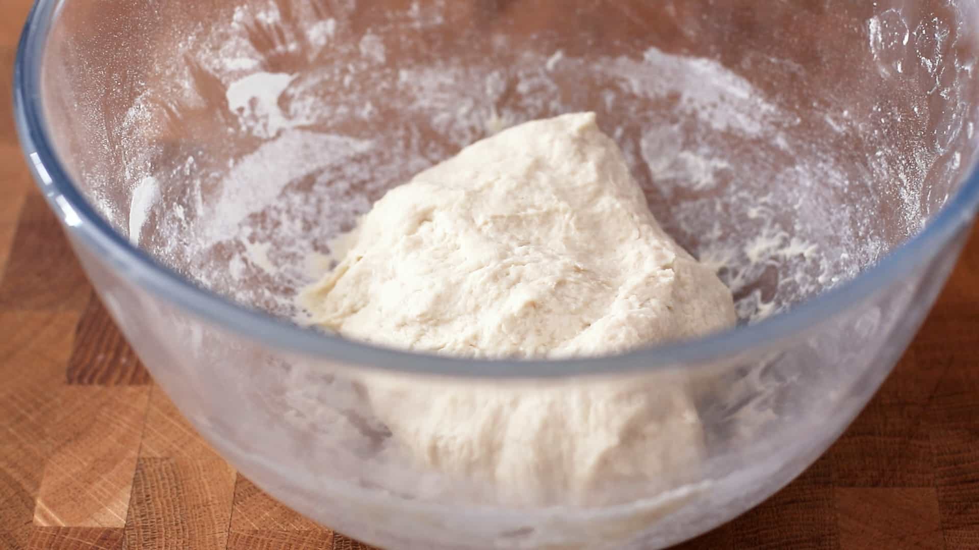 A shaggy ball of bread dough in a bowl