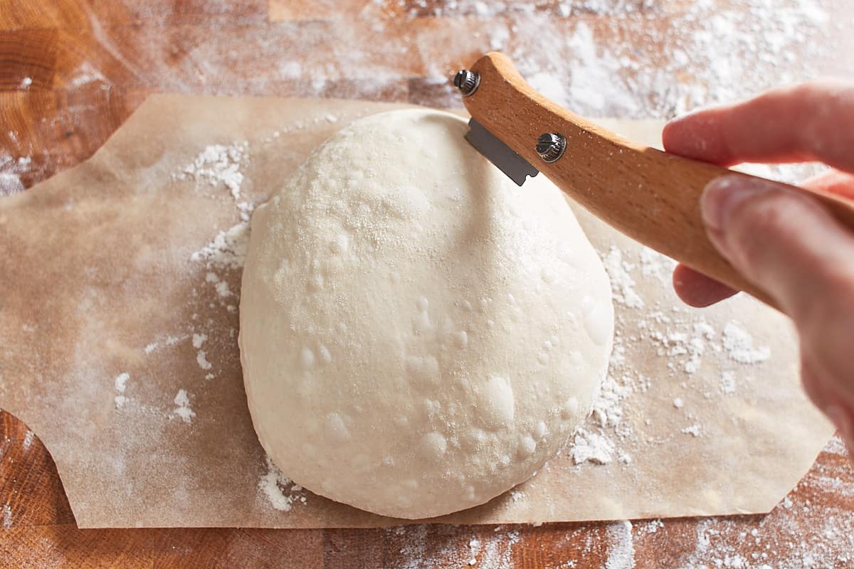Making a cut across the dough ball