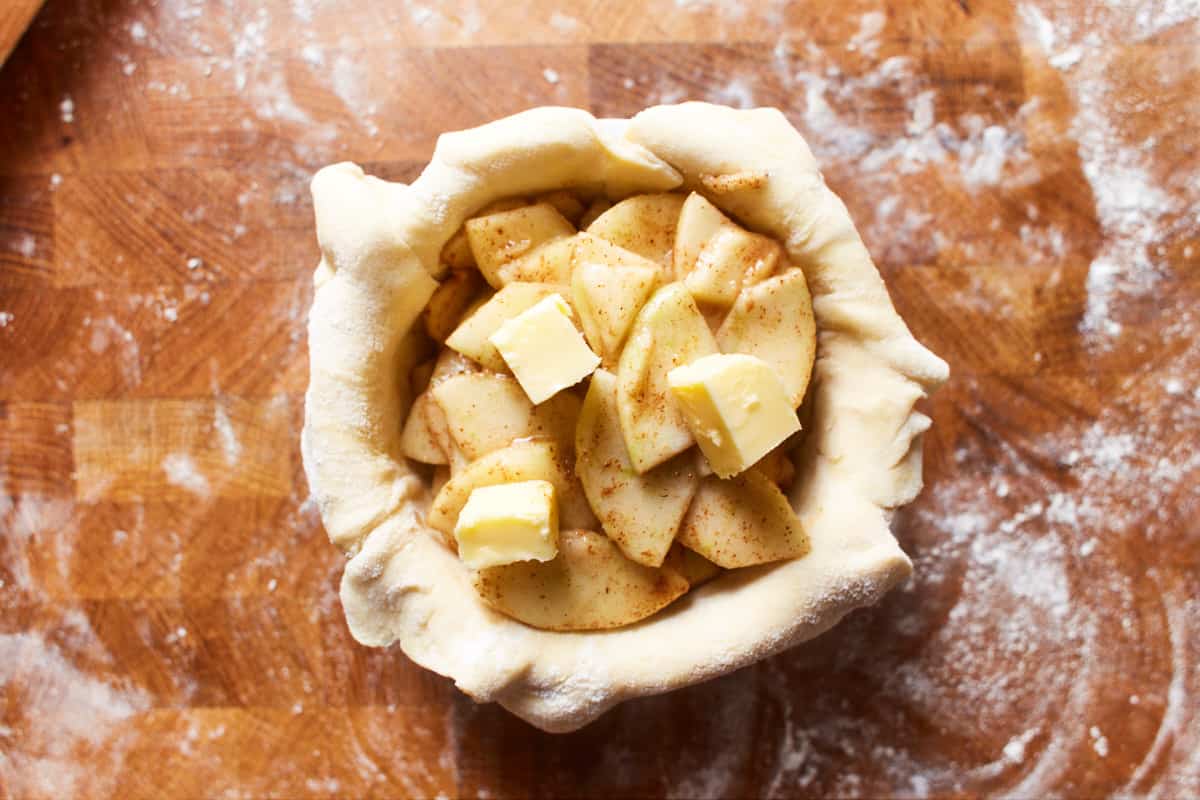 Apple filling and butter filled into the pie crust