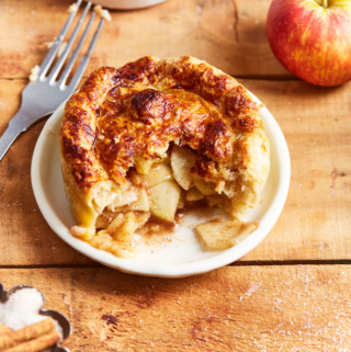 Half eaten mini apple pie on a plate