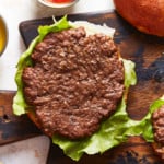 Cooked air fryer hamburger on a burger bun with lettuce.