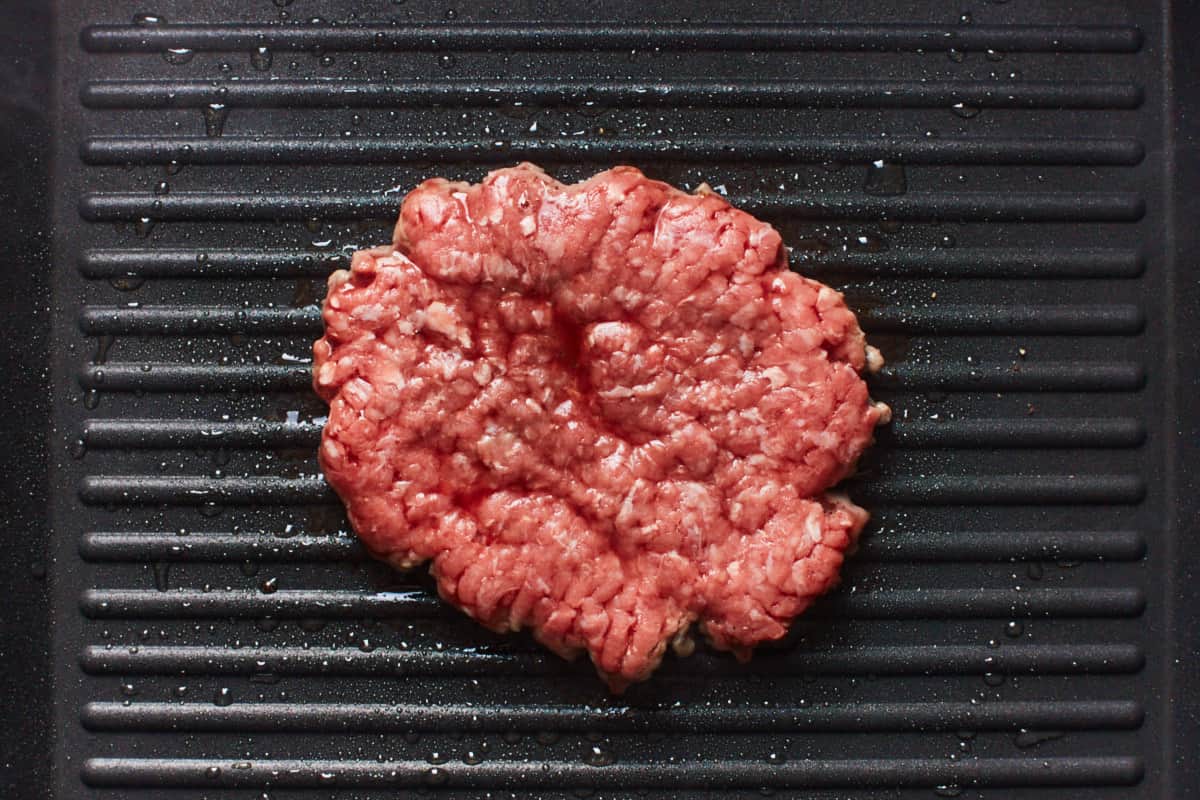 Cooking a beef patty in a grill pan
