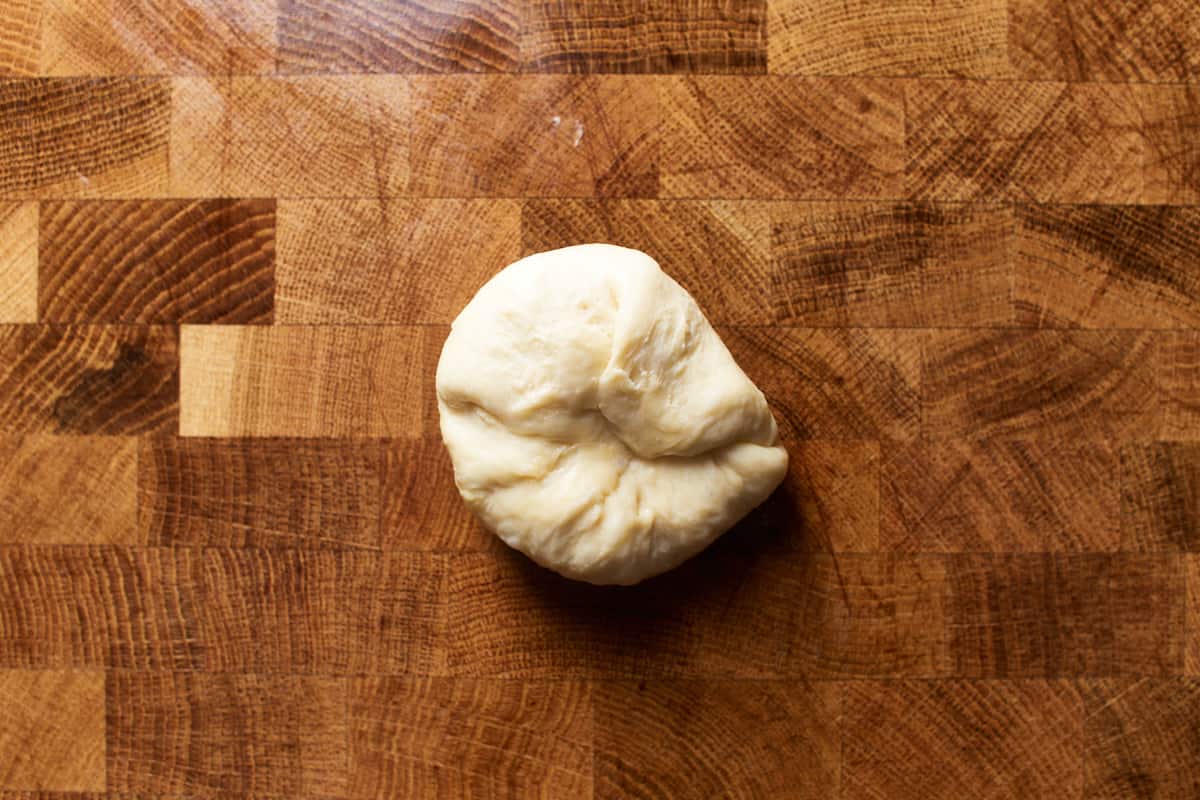 Stretched and folded piece of dough on a work surface
