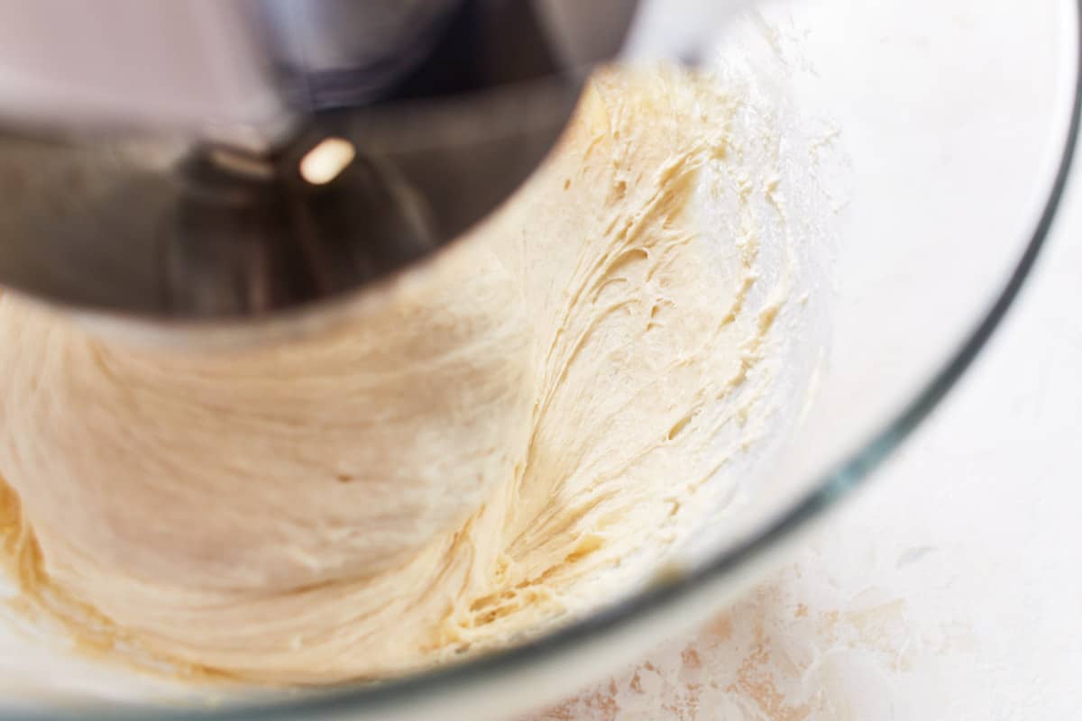 All dough ingredients being kneaded in a bowl