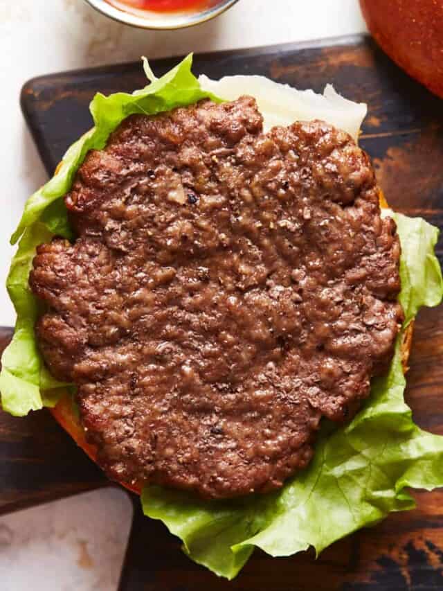 Cooked patty on a burger bun with lettuce