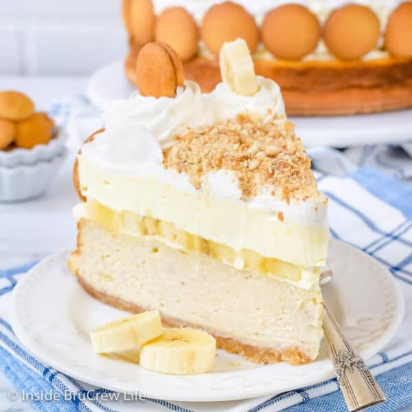 a slice of cheesecake topped with layers of bananas, pudding, and whipped cream
