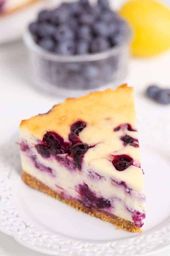 slice of blueberry cheesecake on a white plate