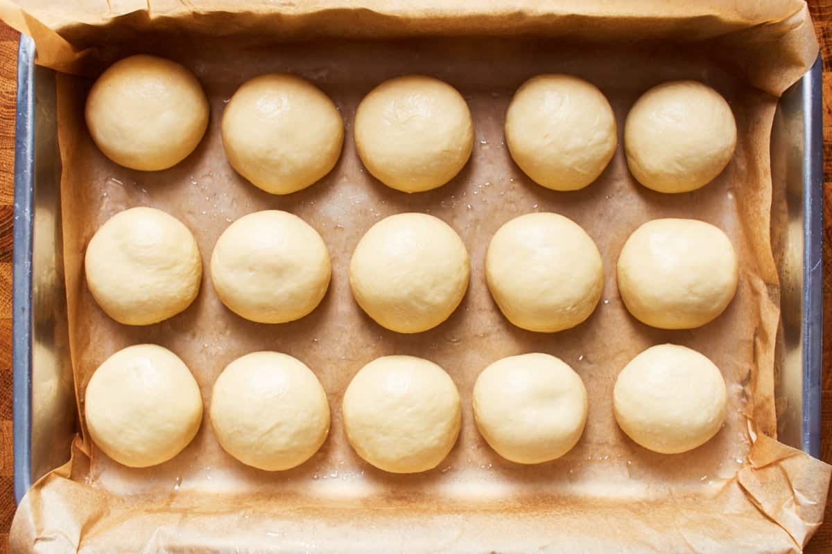 Unbaked, shaped rolls in a baking pan