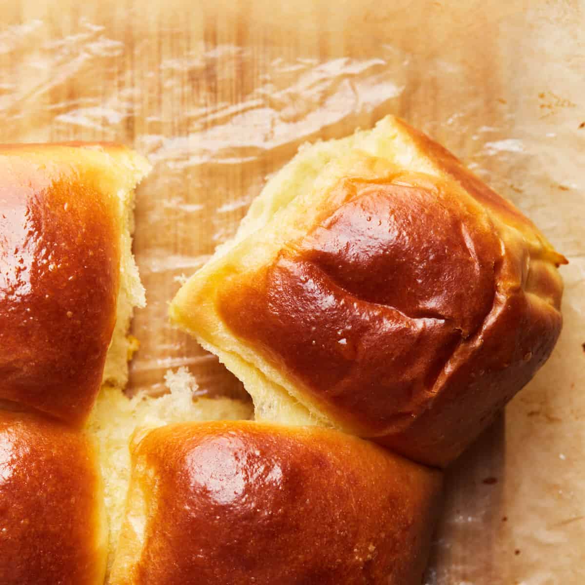 Top down view of a dinner roll on baking paper