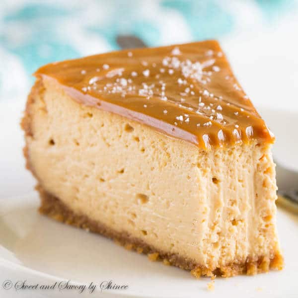 a slice of cheesecake with dulce de leche sauce on a white plate