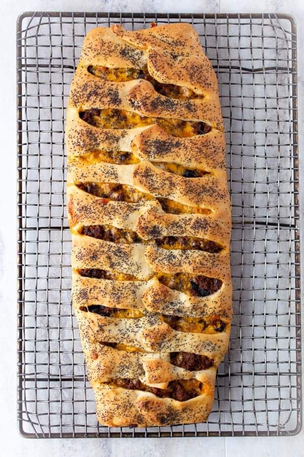 Baked Stromboli filled with ground beef on a cooling rack