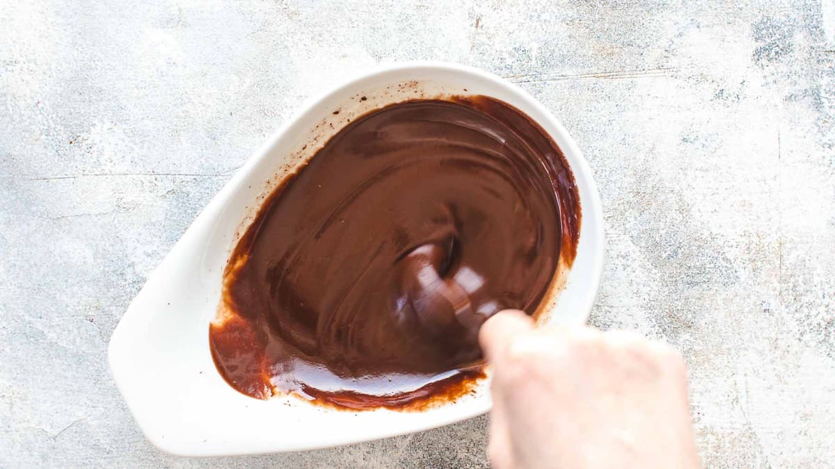 Stirring a chocolate ganache in a bowl