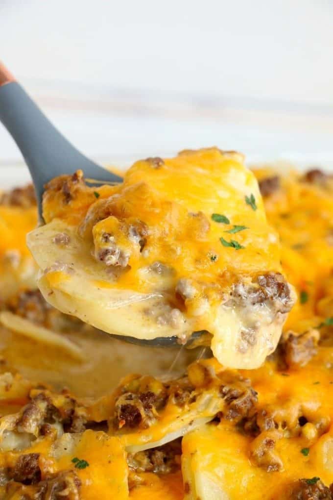 Baked potatoes, ground beef and cheese on a spatula