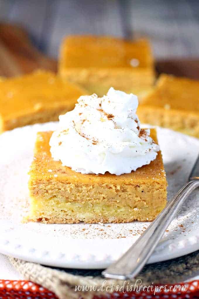 A slice of pumpkin cake with whipped cream on top