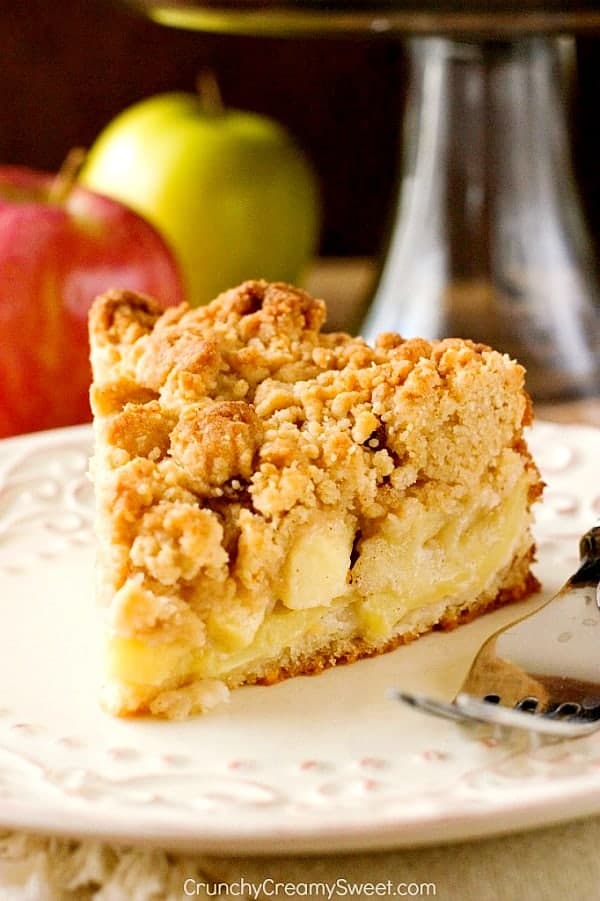 A slice of apple crumb cake on a dessert plate