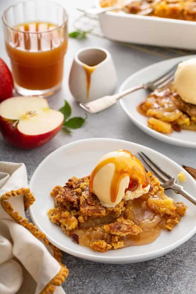 Apple dump cake topped with ice cream and caramel