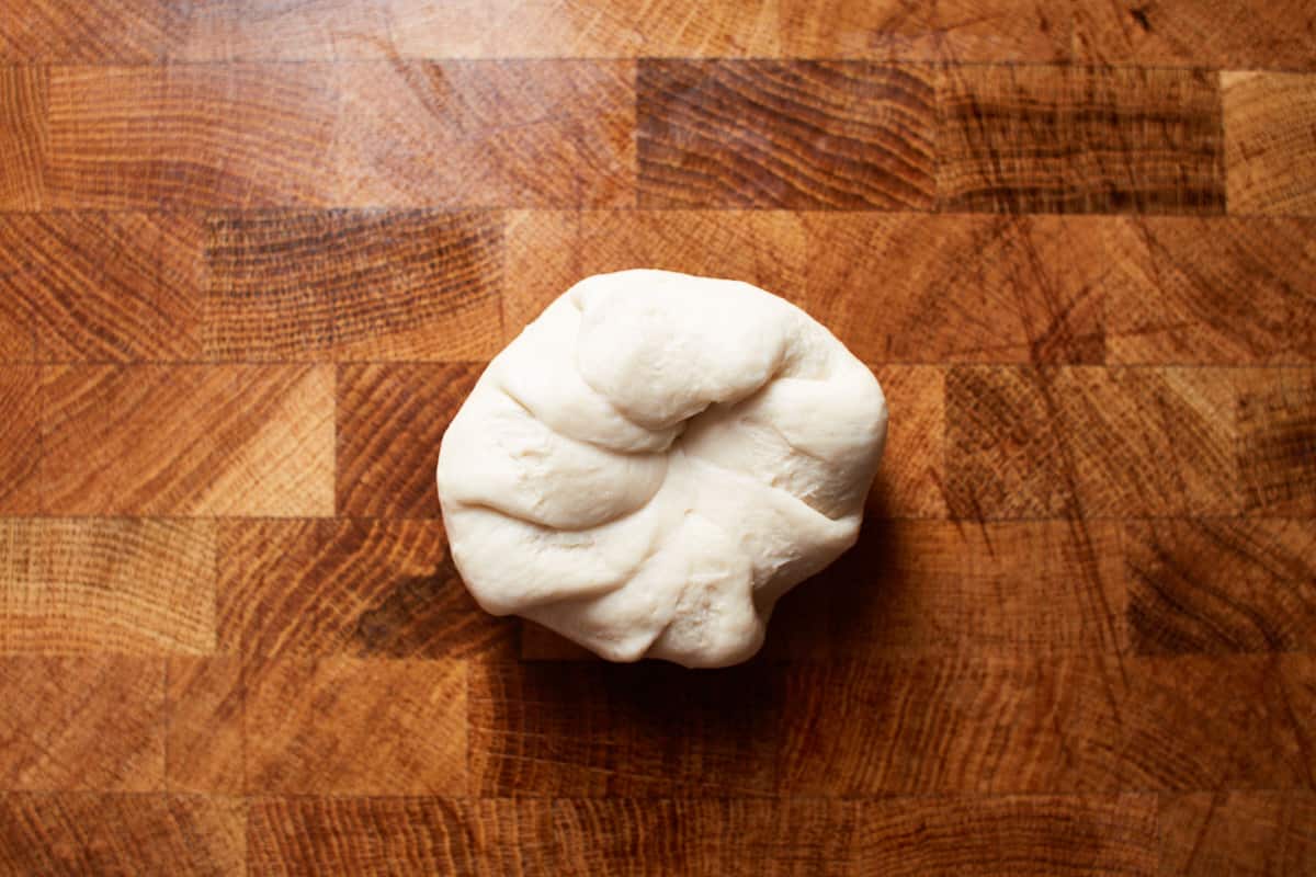 A round piece of dough with open seams