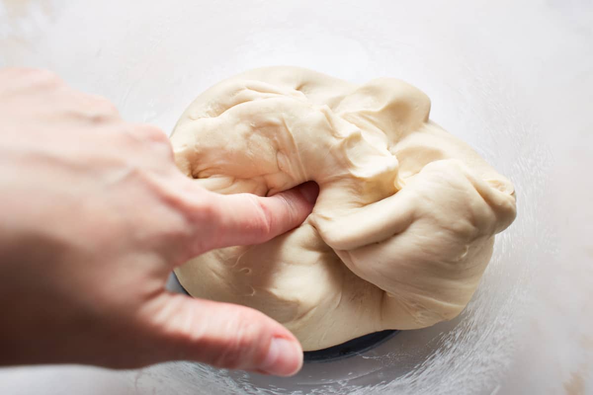 Pressing a finger into kneaded bread dough