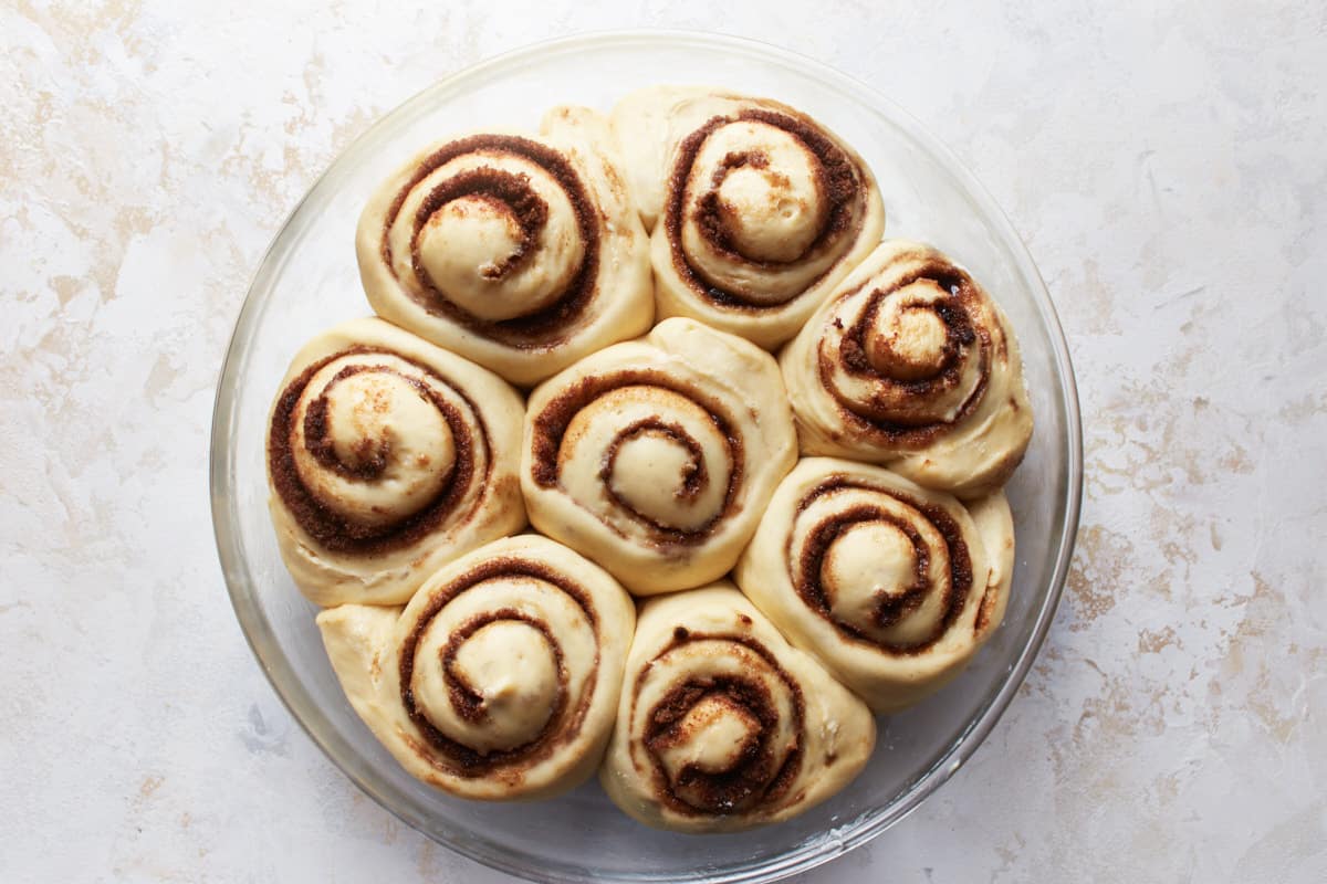 Risen cinnamon rolls in a baking dish