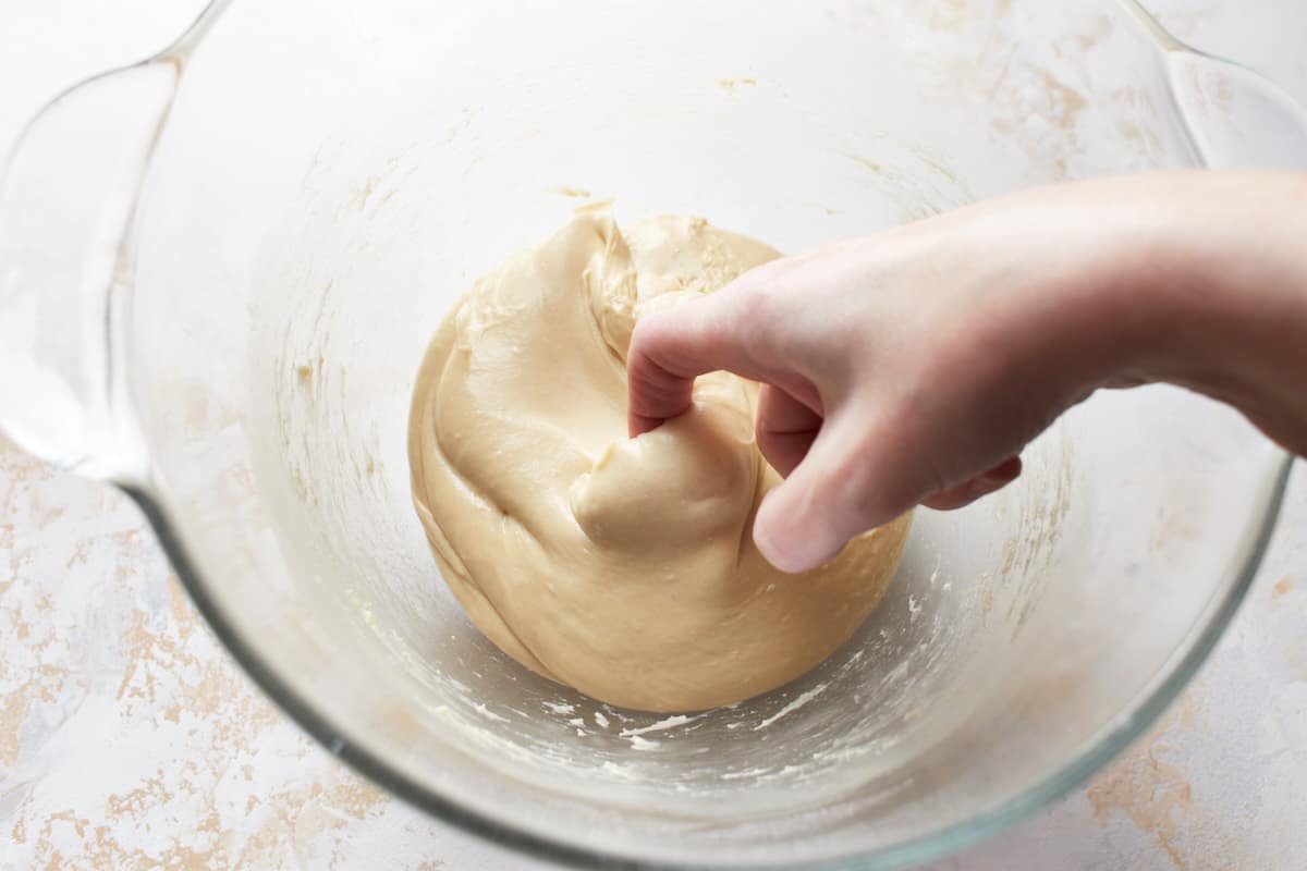 Hooking the index finger into a bread dough