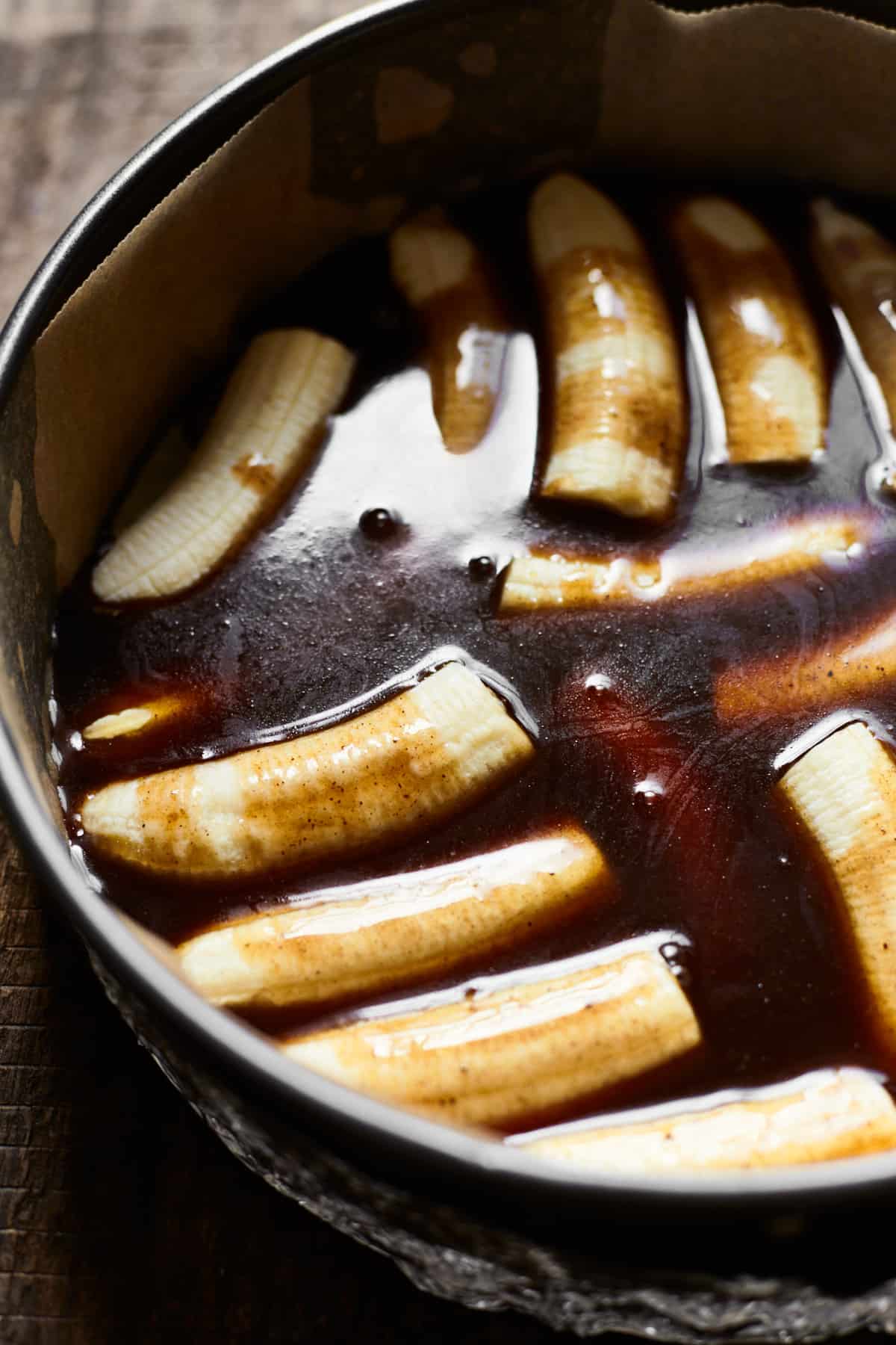Bananas in a springform pan topped with rum sauce