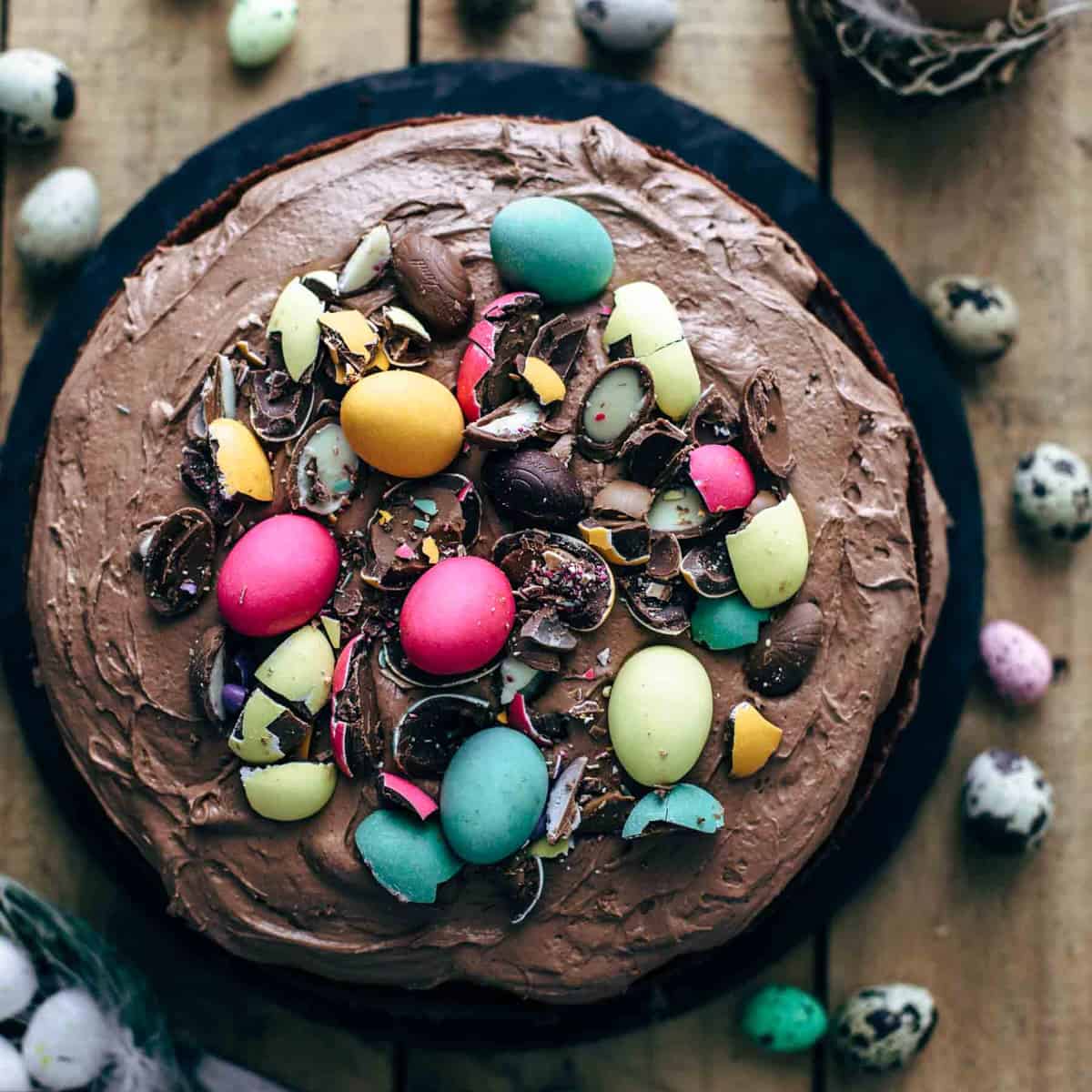 Top view of a frosted chocolate cake with chocolate eggs on top