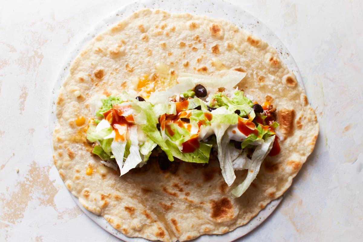 Open tortilla wrap filled with a variety of fillings