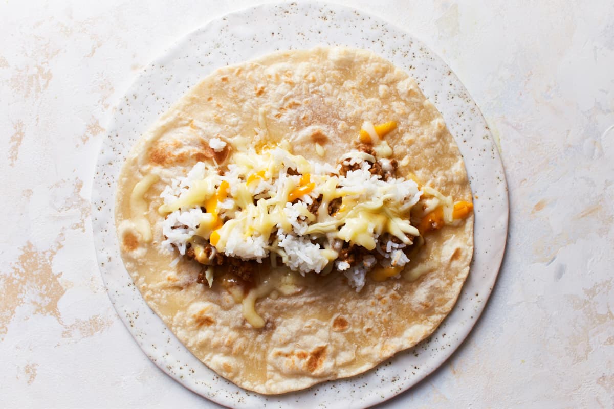 Beef, rice, and cheese on a tortilla wrap