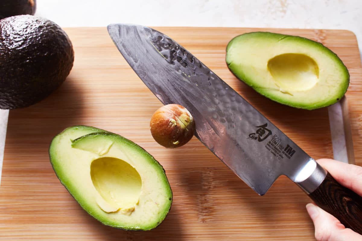 Removed avocado seed on a large knife