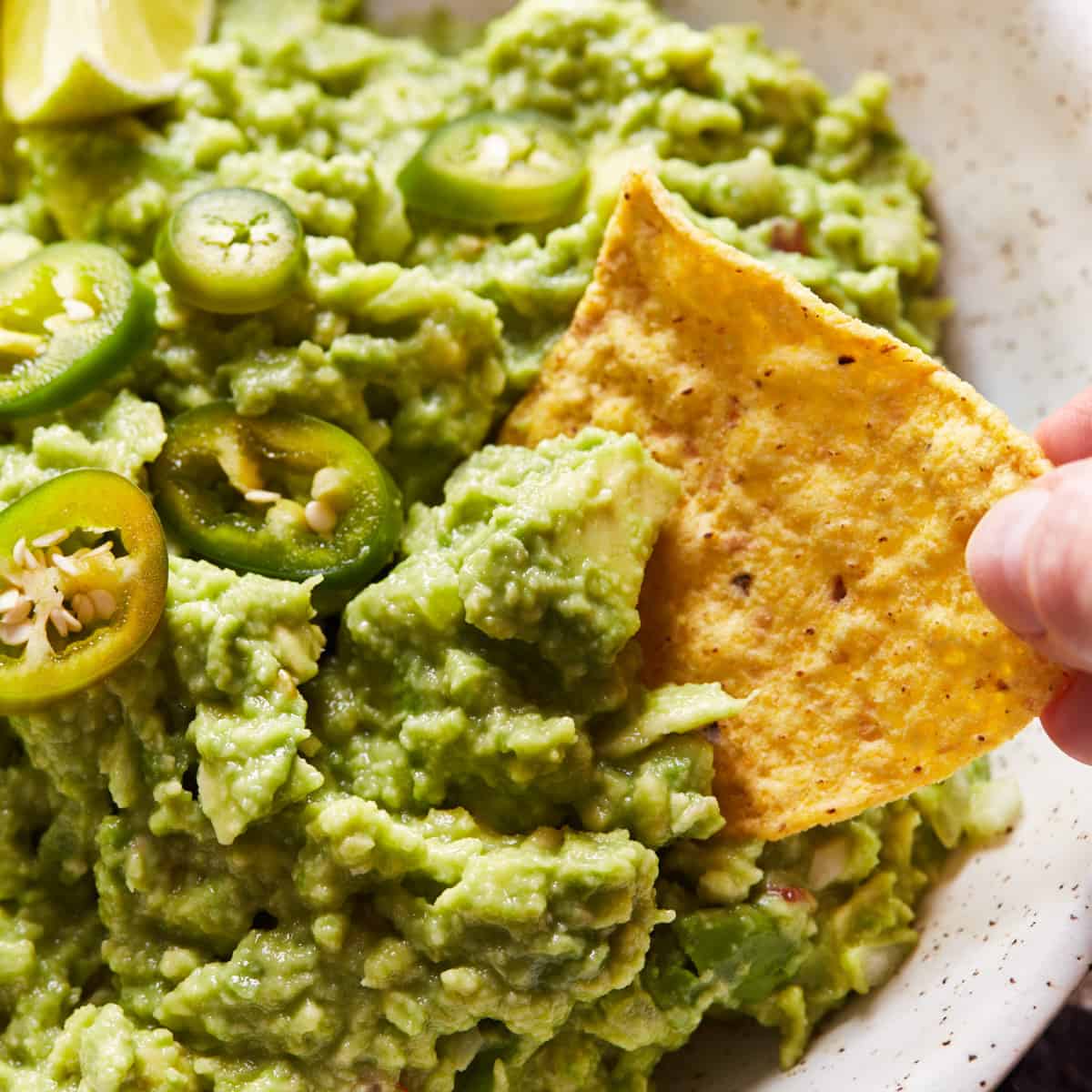 Scooping some guacamole with a tortilla chip