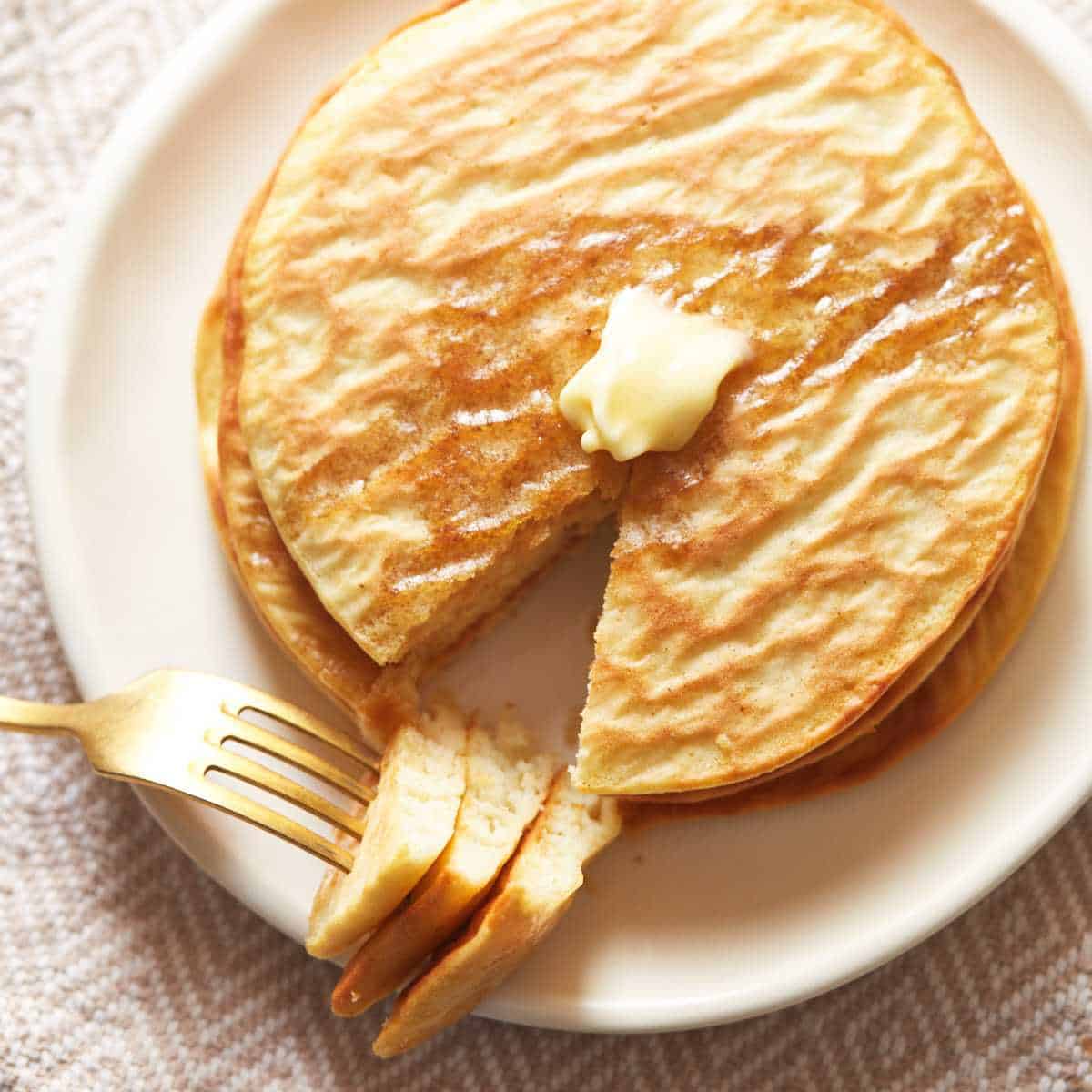 air fryer pancakes with butter and fork