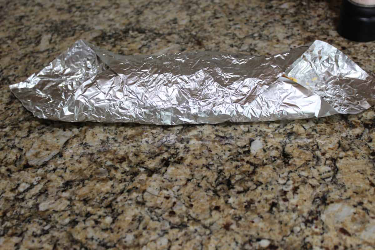 grease chicken with oil and put in foil