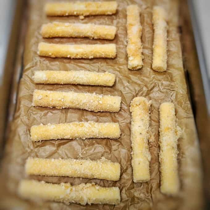 mozzarella sticks in parchment lined trays