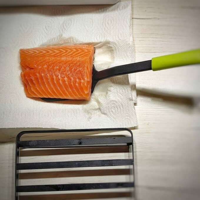 salmon fillet on the air fryer rack skin side down